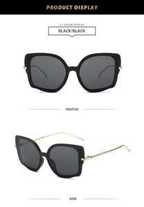 Detailed views of black cat-eye sunglasses with gold twisted metal temples on white background