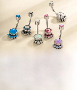 Macro shot of titanium navel rings with colorful opals and zircon stones in 10mm length