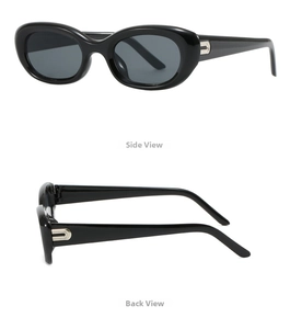 Detail view of vintage oval sunglasses with glossy black frames and silver U-shaped accents