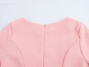 Close-up of pink tweed dress back featuring a hidden zipper and tailored seams