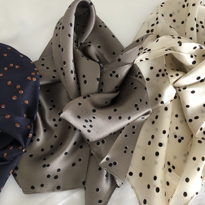 Three premium silk scarves in navy, beige, and taupe with classic polka dot pattern