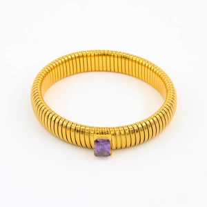 Macro view of gold snake-patterned bracelet with a rectangle purple zircon inlay