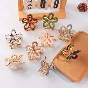 Floral acetate hair claws in tortoise and pastel colors on white decorative background