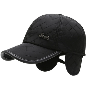 Winter quilted baseball cap with ear flaps and metal jeans badge on black fabric