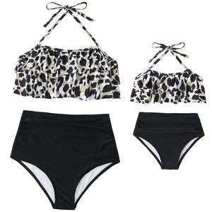 Detail view of two-piece leopard print swimsuit with ruffles and high-waisted black bottoms