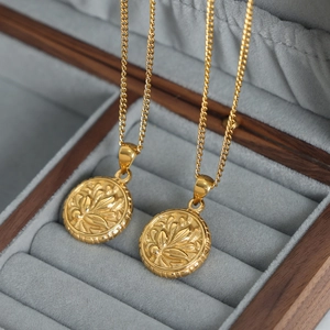 Vintage gold-plated floral pendant necklace displayed in a premium velvet jewelry box