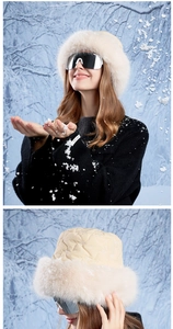 Close-up of beige quilted winter bucket hat with plush faux fur trim and diamond stitching