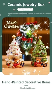 Detail of a ceramic Christmas tree jewelry box featuring a teddy bear relief and gold star