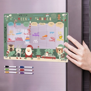 Close-up of clear magnetic weekly planner on fridge with Santa theme and 8 dry erase markers