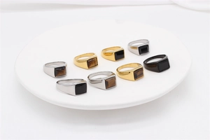 Detail shot of vintage square tiger eye and onyx stones set in polished steel rings