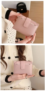 Detailed view of pink textured leather bifold wallet with snap closure and card slot
