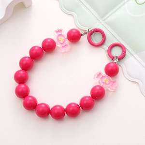 Detail of rose pink acrylic beaded phone chain with candy-shaped charms and metal hooks