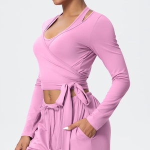 Detail view of pink yoga set showing wrap front tie waist and soft knit texture