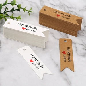 Detail showing kraft and white swallowtail tags with Handmade with love print