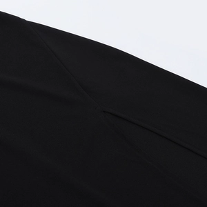 Close-up of the side slit detail on a sexy black V-neck backless maxi dress fabric