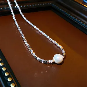 Minimalist freshwater pearl necklace with faceted silver beads shown in a close-up view