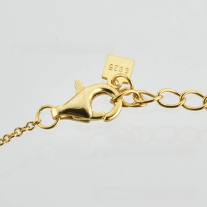 Macro shot of S925 sterling silver stamp on a gold-plated punk snake chain bracelet