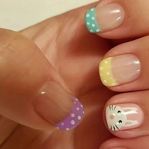 Easter themed press-on nails featuring cute white bunny art and colorful polka dots