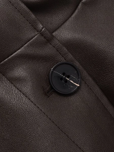 Macro detail of dark brown faux leather texture and black button stitching on casual jacket