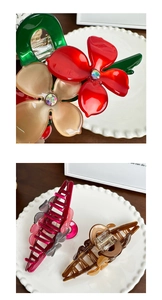 Detailed view of acetate flower claw clips with rhinestones and glossy finish