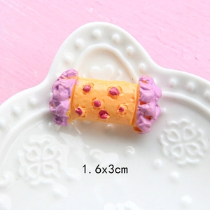 Close-up of a 1.6x3cm yellow and pink resin candy miniature for DIY dollhouse crafts