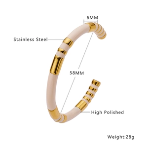 Detail of 6mm wide gold and white striped stainless steel cuff with high polished finish
