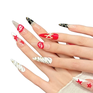 Red star press-on nails with 3D lip charms, zebra patterns and gold studs in stiletto shape