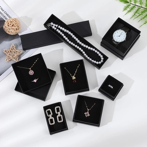Various black kraft paper jewelry gift boxes for necklaces, rings, and watches on white background