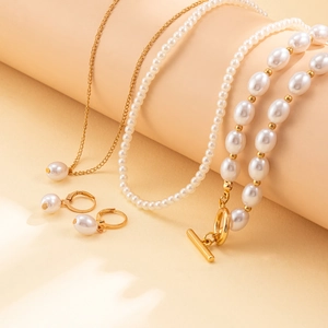 Detail of multi-layer faux pearl necklace set with heart charm and elegant OT toggle clasp