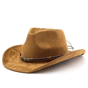 Detail of brown suede cowboy hat with dark leather band and metal skull ornament