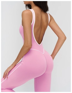 Deep U-shaped open back detail of pink yoga bodysuit with white contrast piping trim