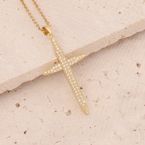 Detailed close-up of 18K gold cross pendant necklace with micro-pave white zircon stones