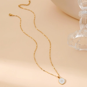 Elegant gold sun pendant necklace with hexagonal charm on a minimalist lip chain