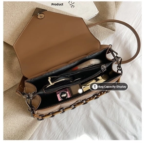 Internal view of brown quilted handbag showing storage space for phone and makeup
