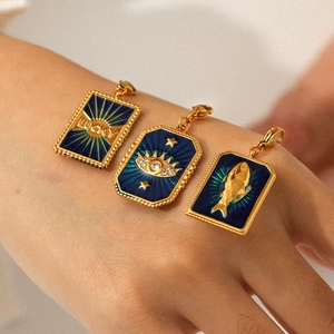 Set of 3 gold stainless steel lucky charms with blue enamel pendants on hands