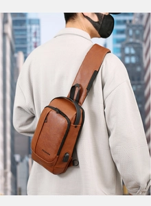 Close-up of brown PU leather men sling bag with external USB charging port and zipper detail