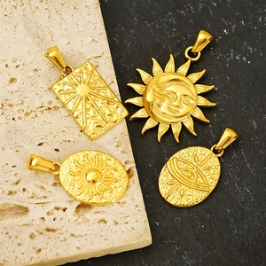 Retro stainless steel tarot sun moon pendants in gold finish on stone background