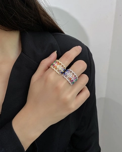 Detail of hollow 925 silver rings with colorful rectangle gemstones on a model hand