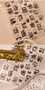 Detail view of 3D gold embossed butterfly nail stickers with floral oil painting art