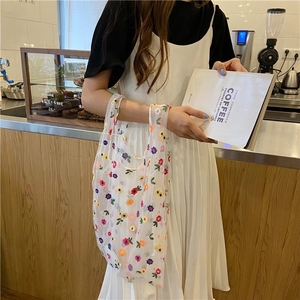 Chic white mesh tote bag with colorful flower embroidery and wide handle design