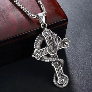 Close-up of vintage silver dragon and skull cross pendant with textured twist chain