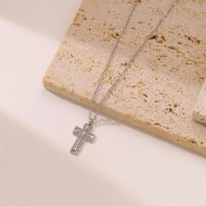 Silver punk cross pendant necklace with micro-pave zircons on a natural stone base