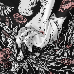 Detailed close-up of fox and floral print fabric texture with soft natural folds