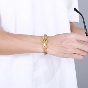 Detailed view of men's gold snake head bracelet with intricate scale textures on wrist