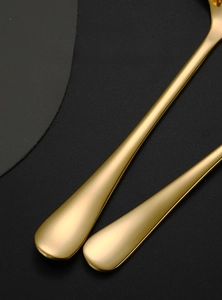 Detail of thickened gold stainless steel long handle with ergonomic matte finish