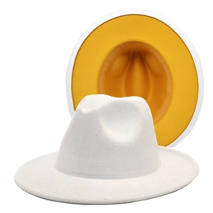 Detail of the white wool fedora hat featuring a contrasting vibrant yellow inner lining