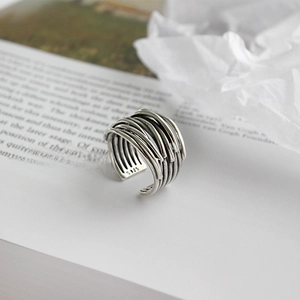 Macro shot of silver S925 multi-layered ring on vintage book pages in soft light