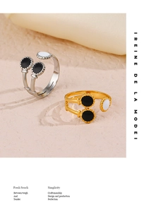 Detail of adjustable French vintage gold and silver rings with black and white enamel dots