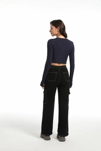Rear view of high waist black wide leg cargo pants with white contrast stitching details