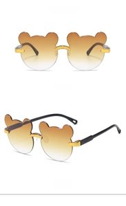 Close-up of stylish brown bear ear sunglasses for kids with gold bridge and black temples